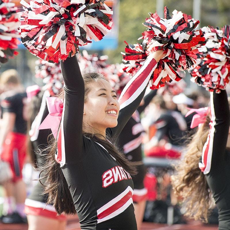 Photo of a cheerleader in her uniform at a game